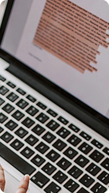 Writer working on a manuscript using a laptop
